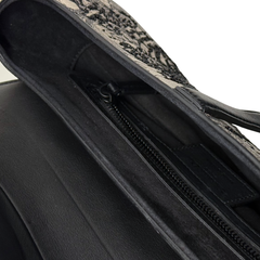 Christian Dior saddle bag interior view showing black zipper track and black lining.