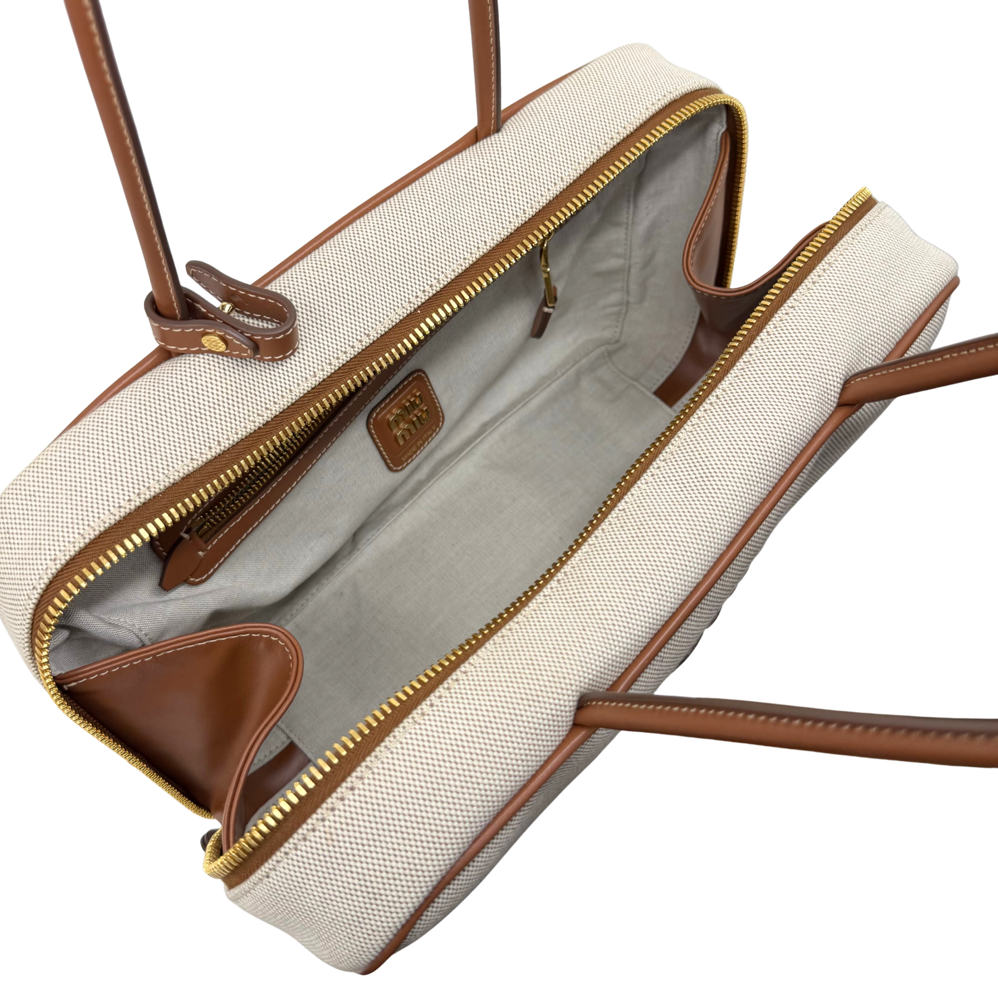 Miu Miu canvas duffel bag with dual zippers, brown leather trim, gold hardware