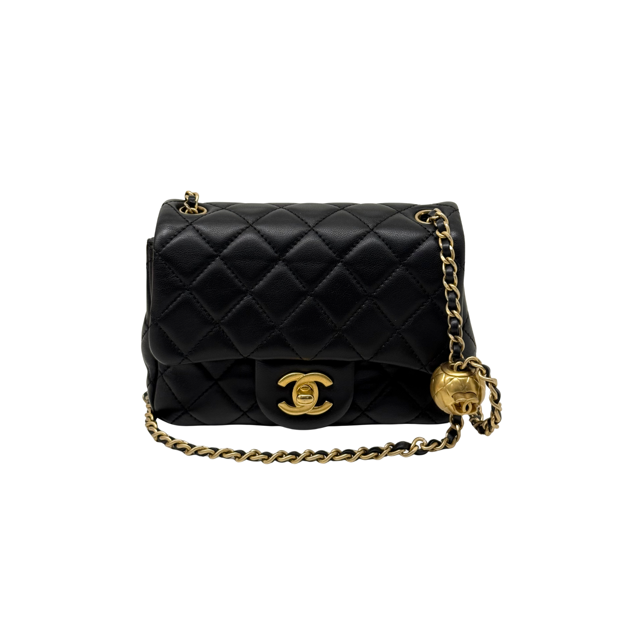 Black quilted shoulder bag with top flap, gold CC clasp, and gold chain tassel pull