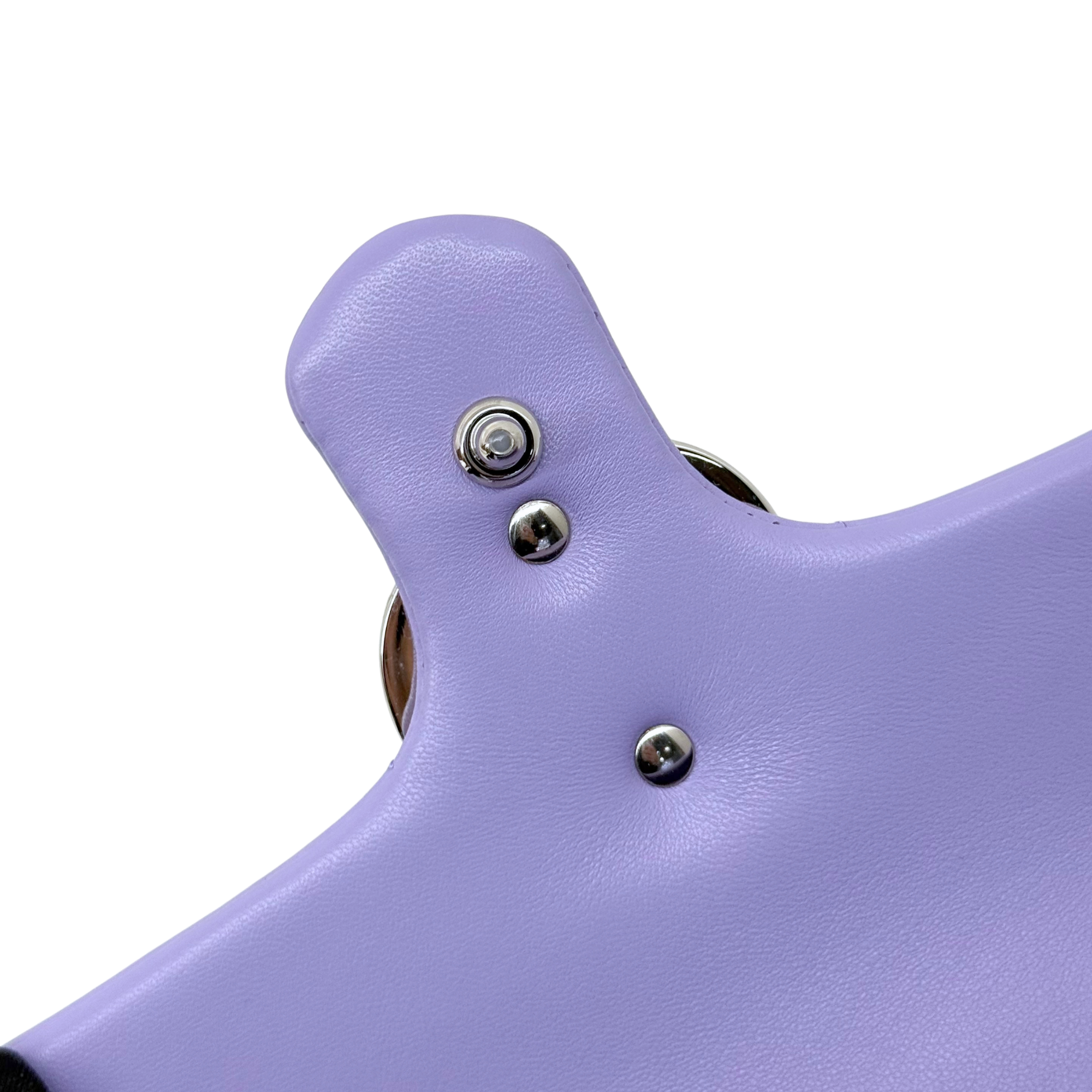Lavender leather bag flap close-up with round metal snap buttons