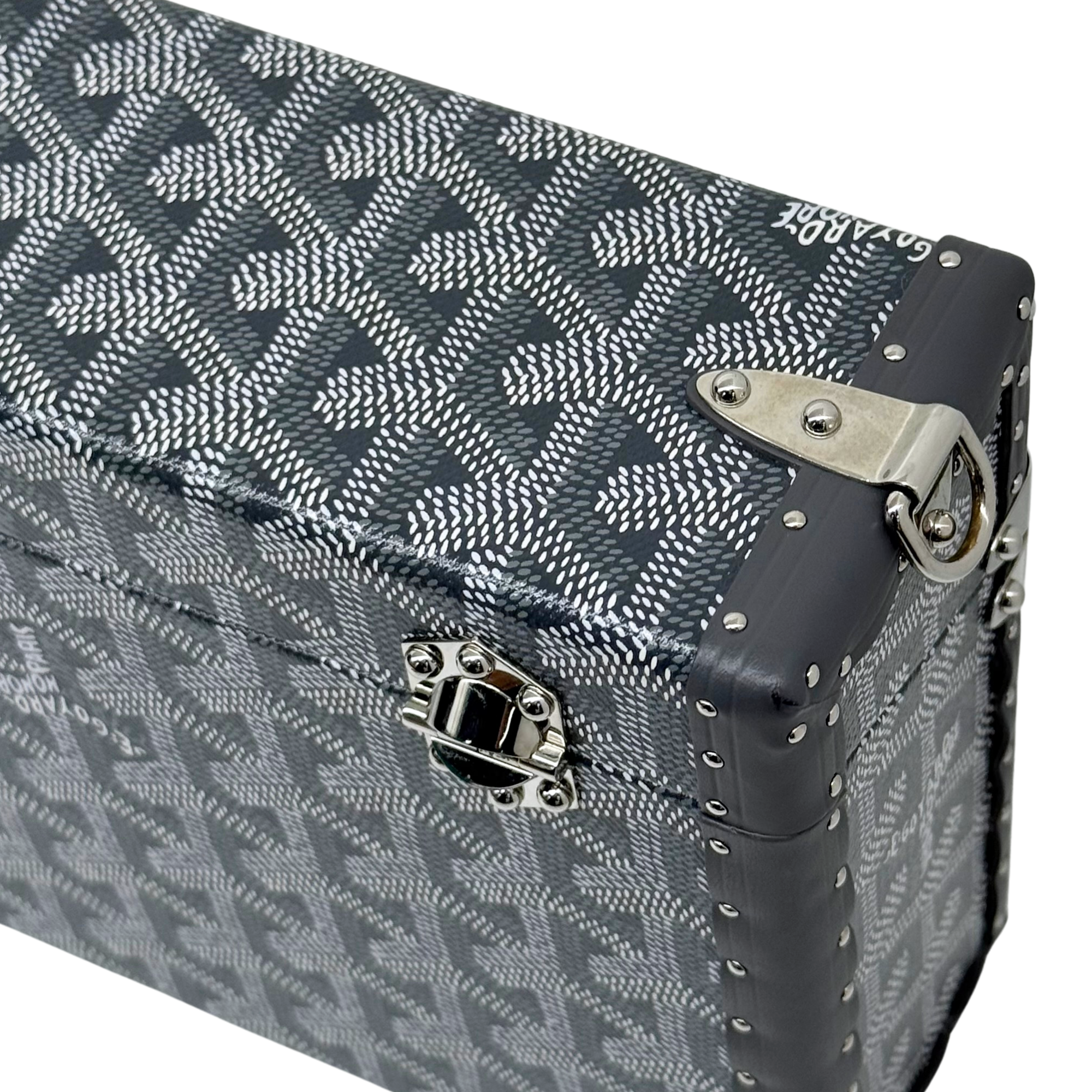 Goyard monogram trunk with black leather corner trim and silver hardware