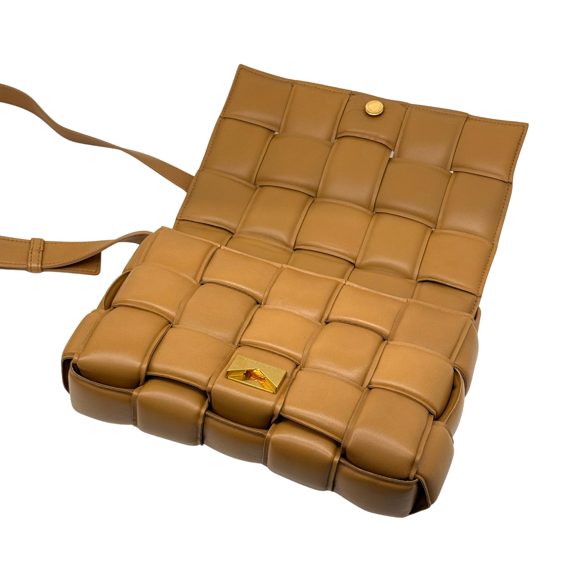 Tan leather bag with front compartment and gold-tone logo hardware on flap