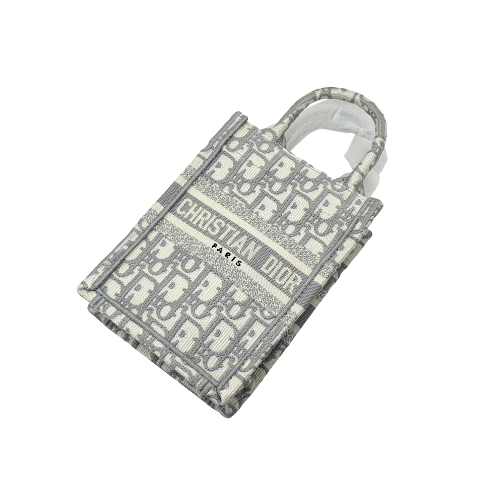 Gray-and-beige Dior monogram mini tote bag with top handles, angled