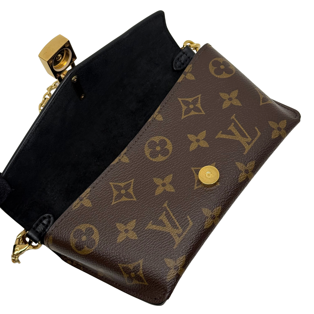Monogram shoulder bag with black flap, brown canvas, and gold-tone clasp