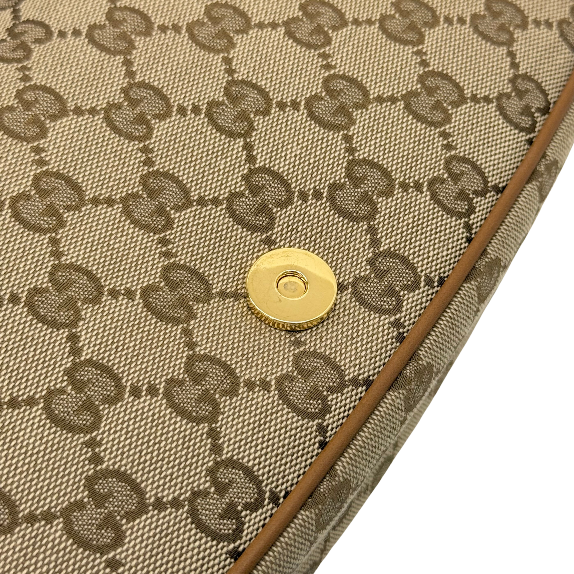 Gucci GG canvas panel with gold snap button and brown leather edge trim