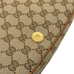 Gucci GG canvas panel with gold snap button and brown leather edge trim